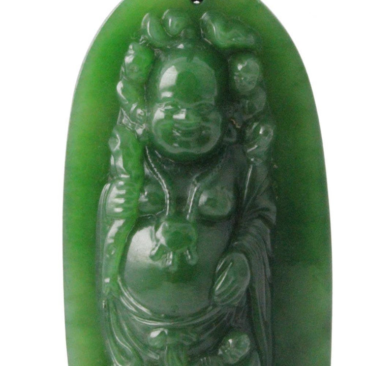 Close up of the carved Buddha image inside the green jade pendant