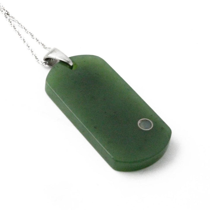 Green rectangular dog tag pendant shown at an angle with a small circular dot near the lower right.
