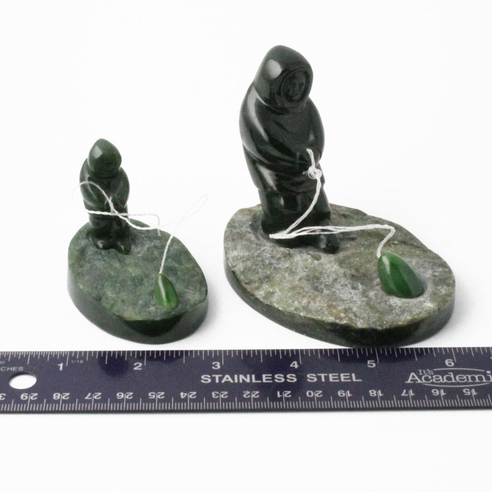 Two nephrite jade fisherman figures with strings and green beads on rock bases