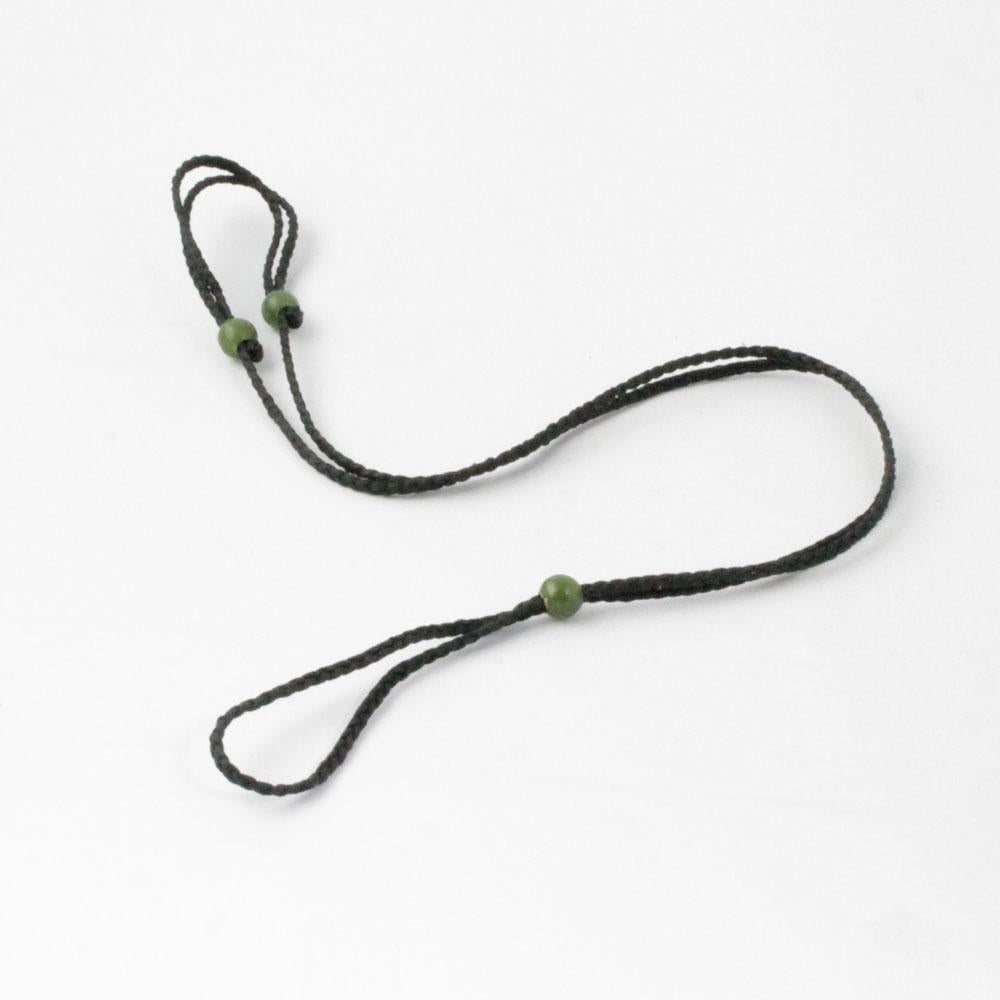 Thick black braided cord necklace with green jade beads and looped ends