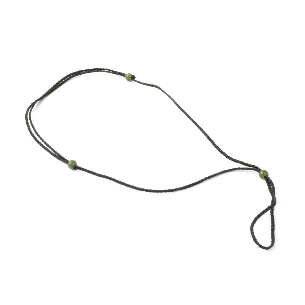 Thick dark brown cord necklace with jade bead accents arranged in a loose loop