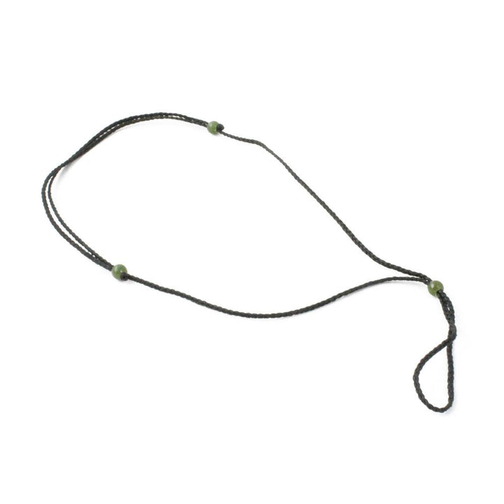 Thick dark brown cord necklace with jade bead accents arranged in a loose loop