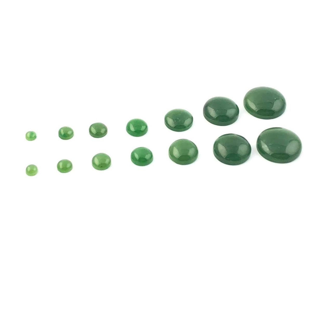Lineup of green round cabochons in varying sizes on a white surface