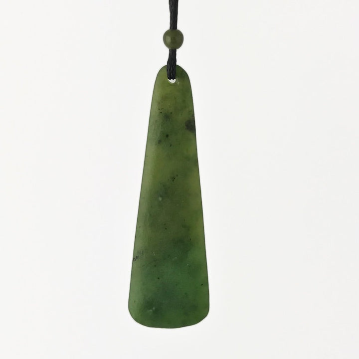 Green jade drop pendant on a black cord with a round bead, photographed against a white background