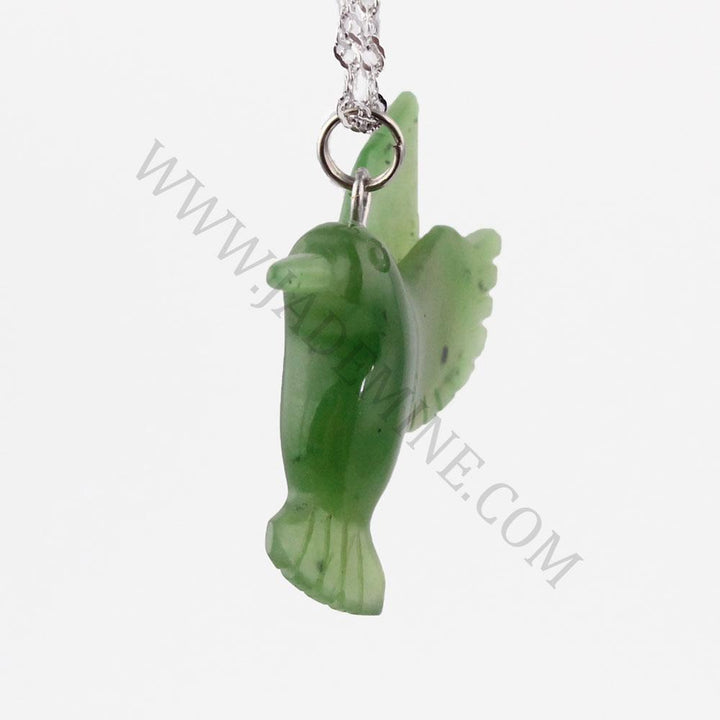 Side view of green jade hummingbird pendant on a silver chain