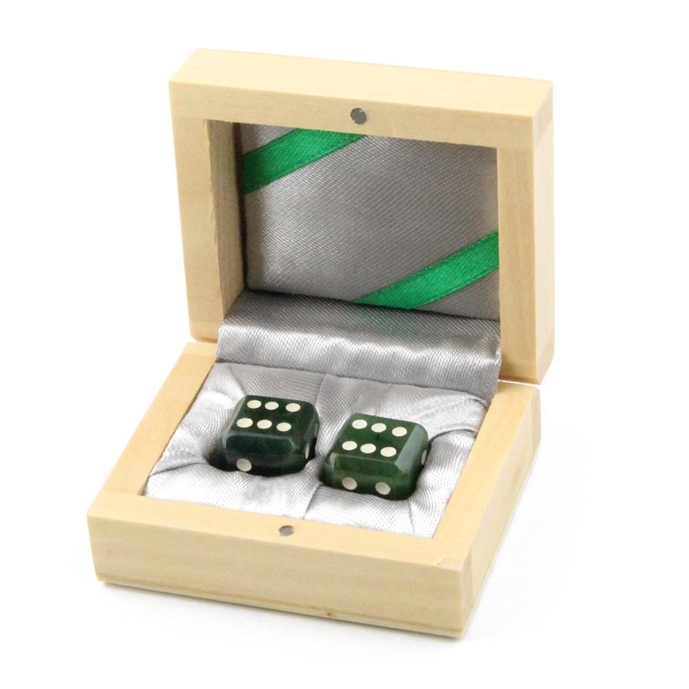 Two green dice in a light wood gift box with silver satin lining.