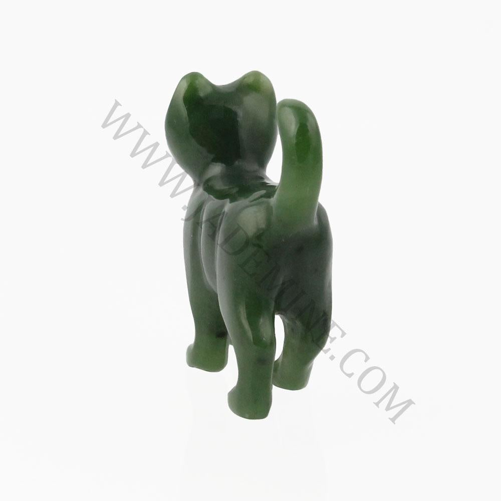 Green cat figurine seen from behind with a curved raised tail