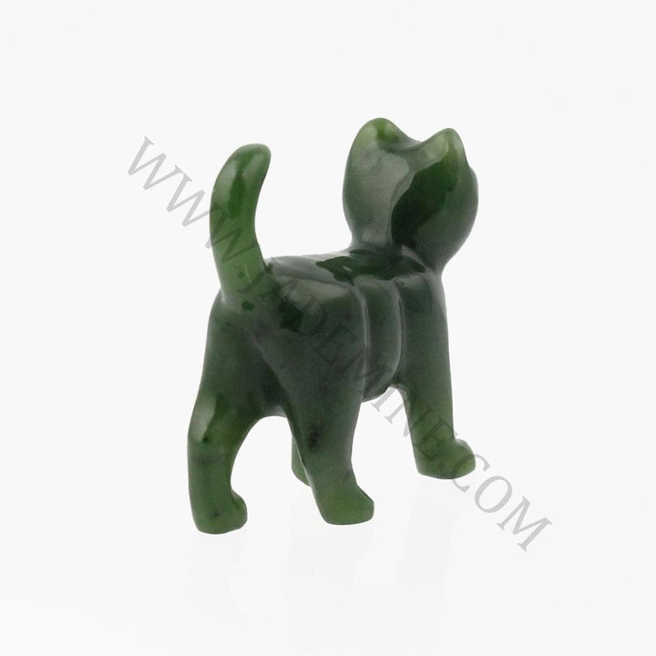 Dark green jade cat figurine seen from behind with tail held high.