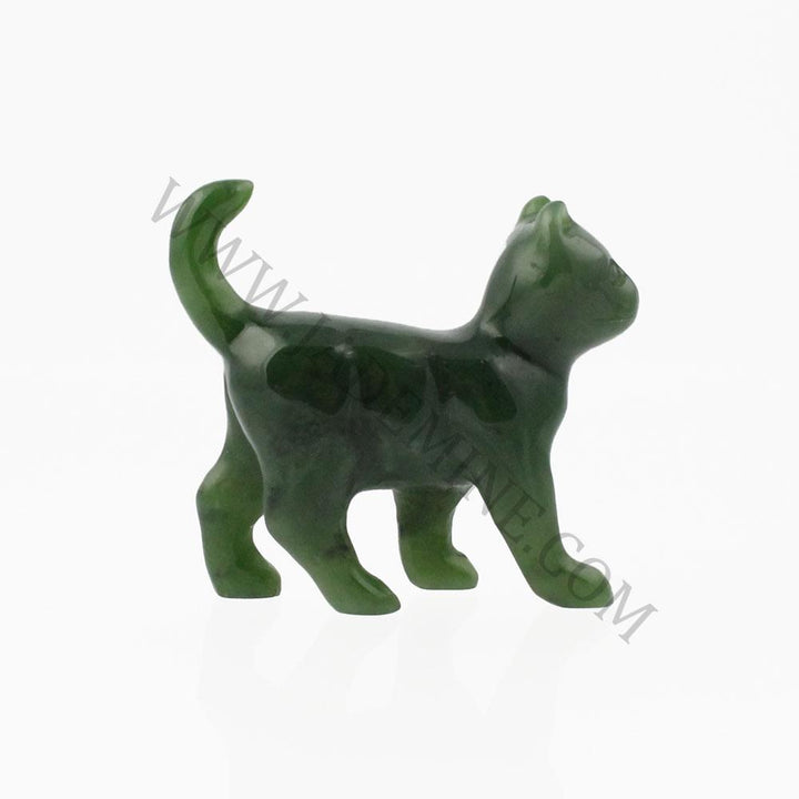 Dark green glass cat figurine in a walking pose with tail curved upward.