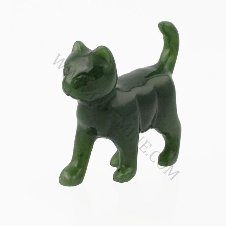 Dark green jade cat figurine walking with head turned and tail raised.