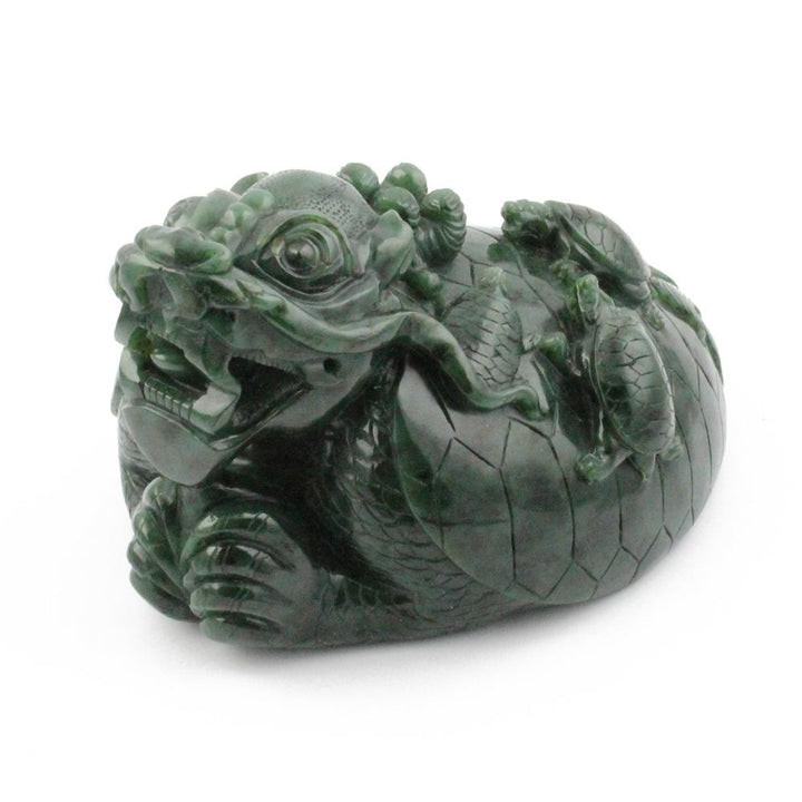 Side view of a dark green jade dragon turtle sculpture showing the head and curled body