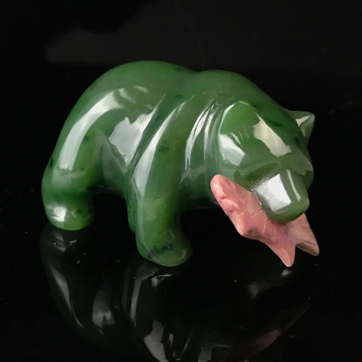 Green jade bear with rhodonite salmon in its mouth, with a black background
