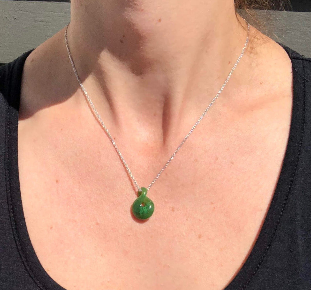 Cassiar Jade Infinity Twist pendant on a silver chain worn around the neck