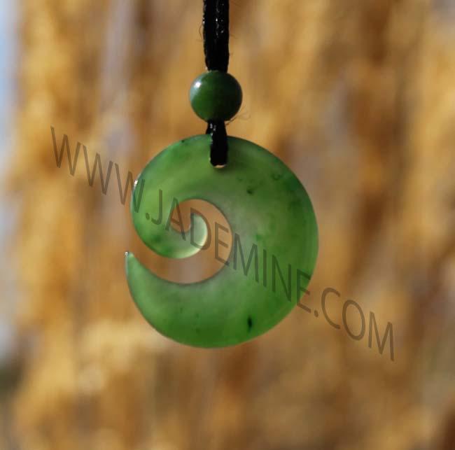Green Jade Pendant with a blurred brown background
