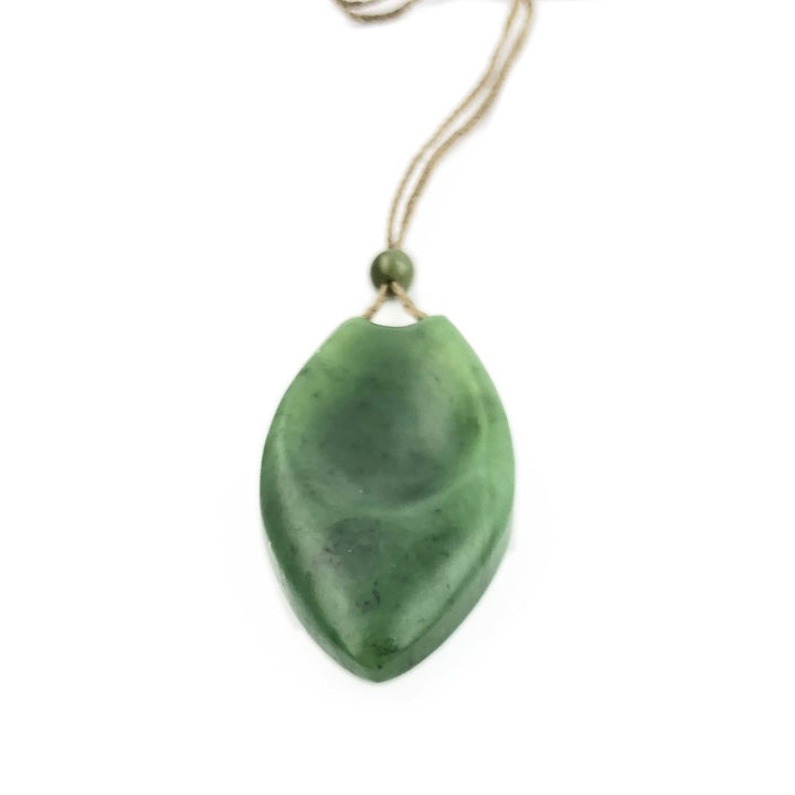 Green jade pendant on a twisted cord with a bead at the top.