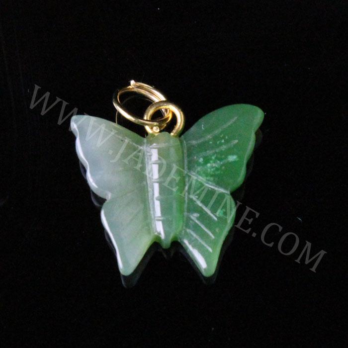 Green butterfly jade charm with a gold-tone loop on black background