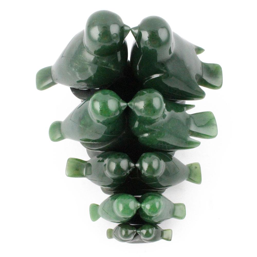 Stacked glossy dark green lovebird figures forming a vertical sculpture