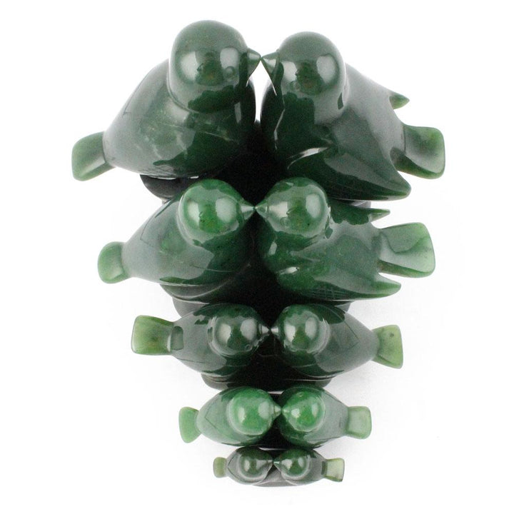 Stacked glossy dark green lovebird figures forming a vertical sculpture