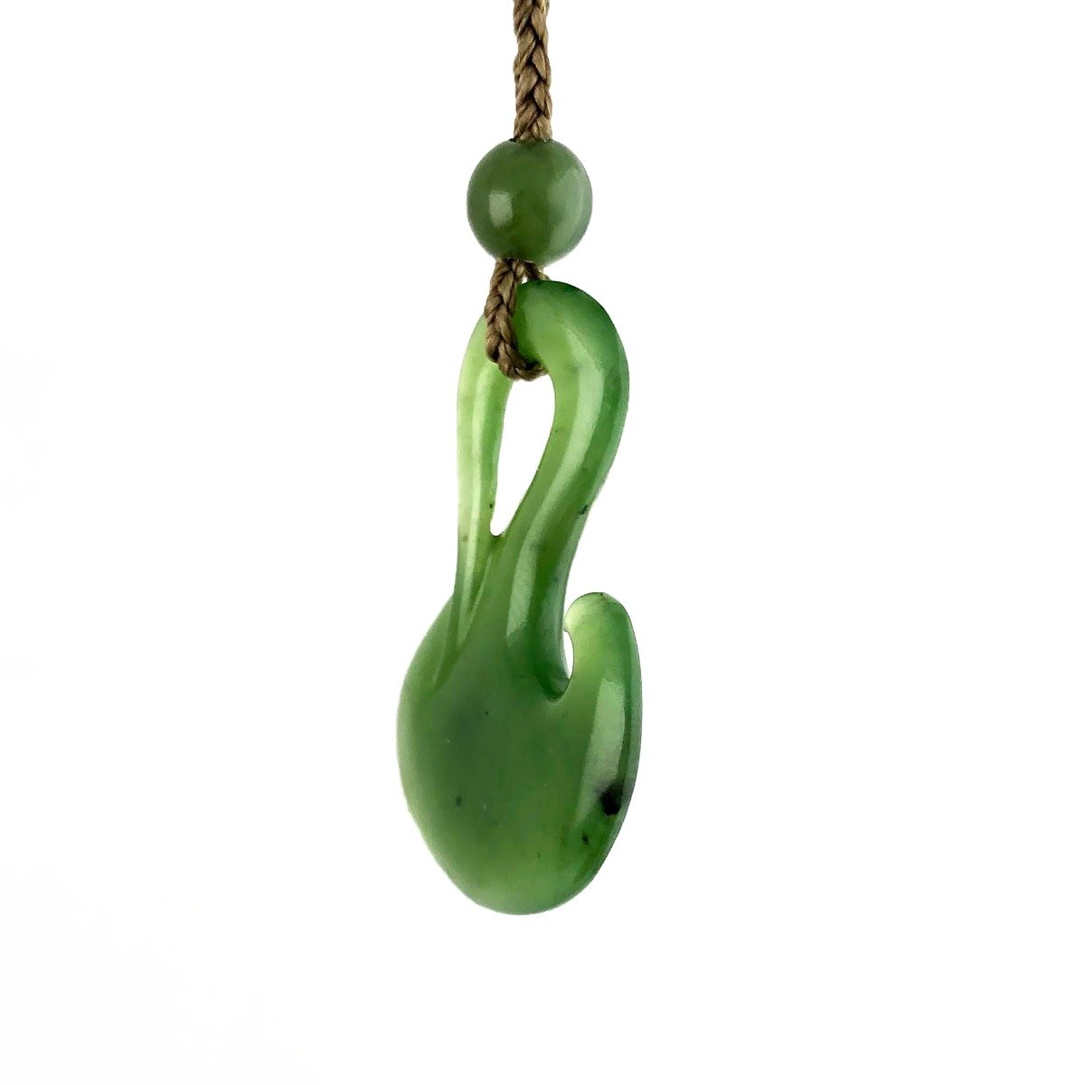 Round green jade bead above curved fish hook pendant on a brown braided cord
