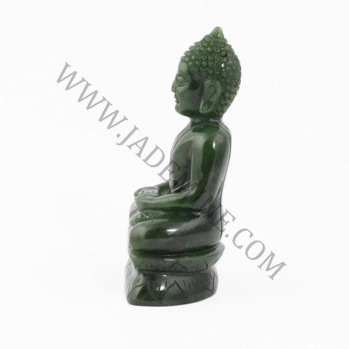 Thai green jade Buddha statue seated in meditation seen in right side profile on a carved base