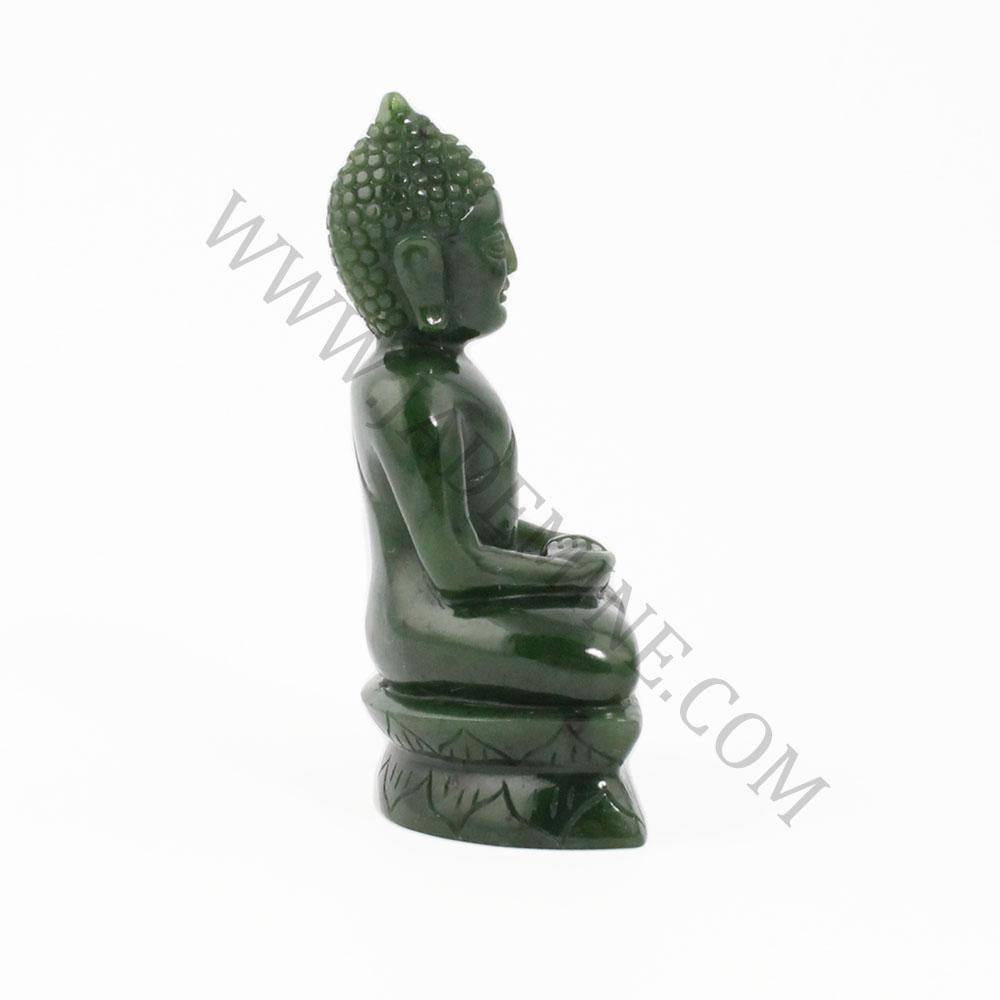 Thai green jade Buddha statue seated in meditation in profile view on a carved base