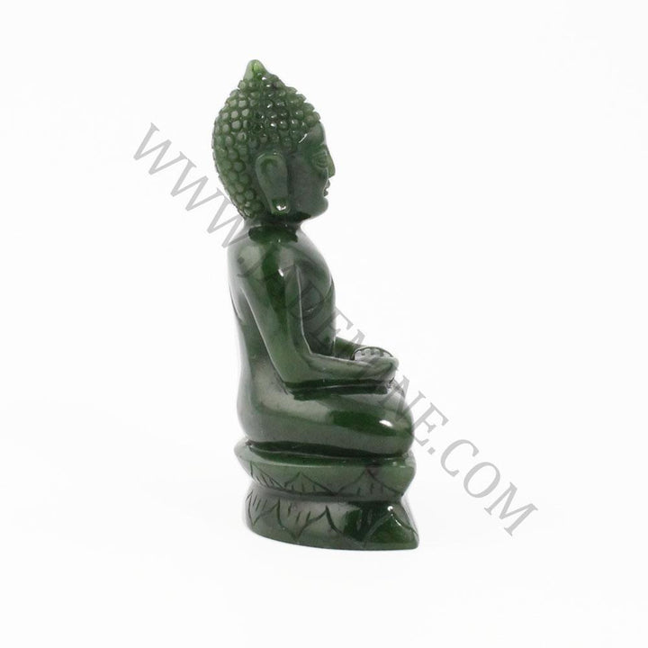 Thai green jade Buddha statue seated in meditation in profile view on a carved base