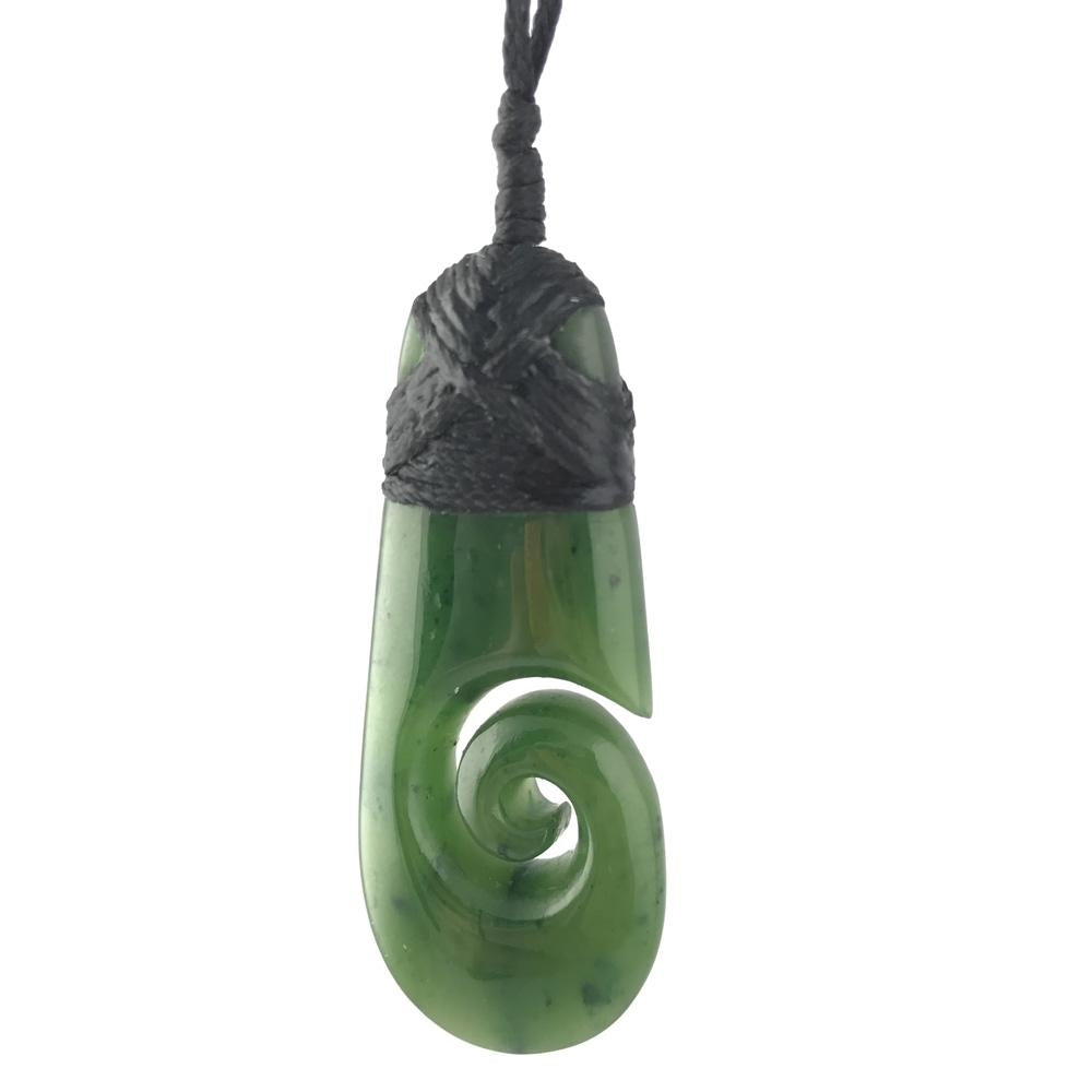 Green jade pendant shaped like a curved teardrop wrapped in black macrame cord