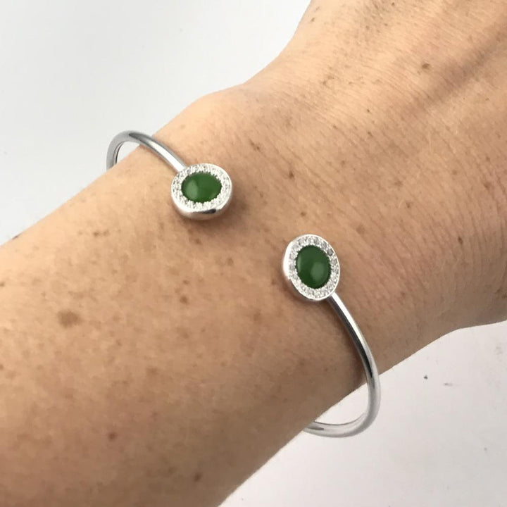 Sterling silver open cuff bracelet with two green jade cabochons at each end