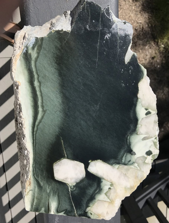 Olive Wyoming rock with green interior and quartz crystal pockets along the broken edge