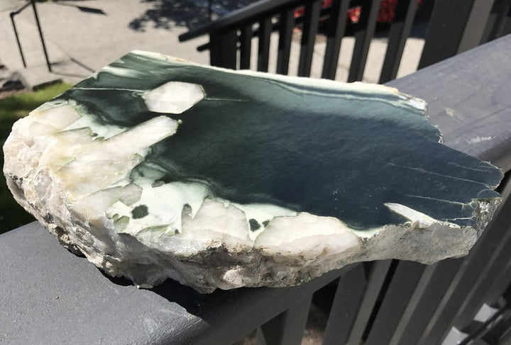 Olive Wyoming specimen with deep green face and white quartz crystals along the perimeter