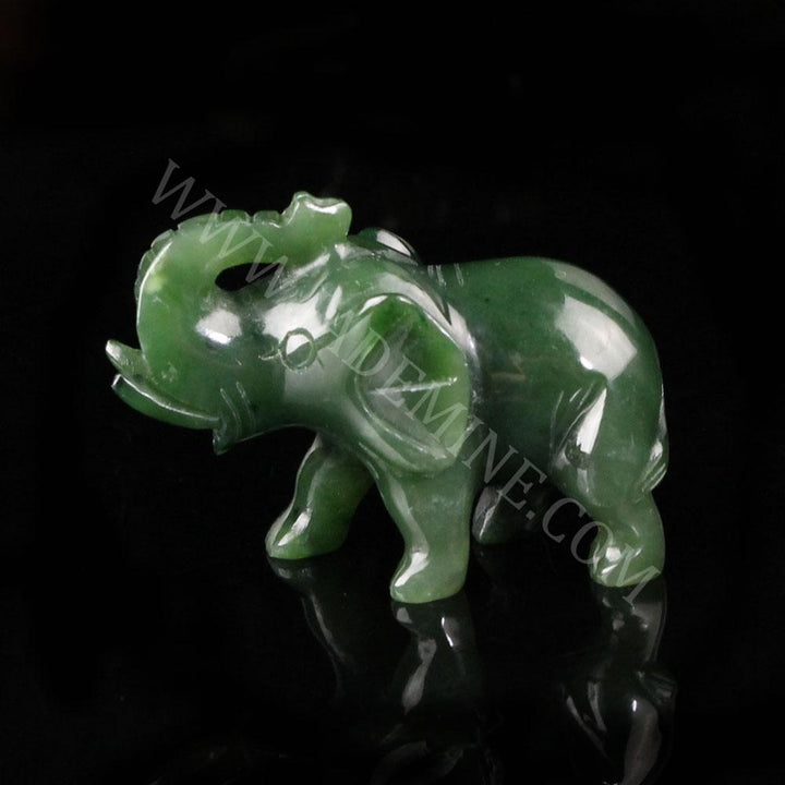 Green jade elephant with a black background, watermark jademine.com on it