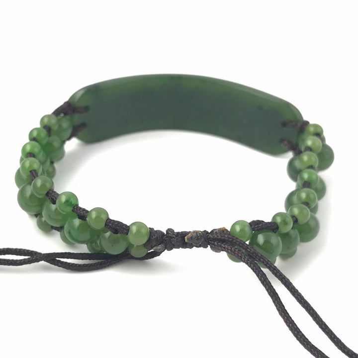 Bracelet 1833-12 green beaded bracelet with a curved central piece on dark cord