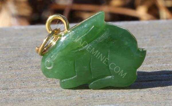 Green jade rabbit charm with a gold loop