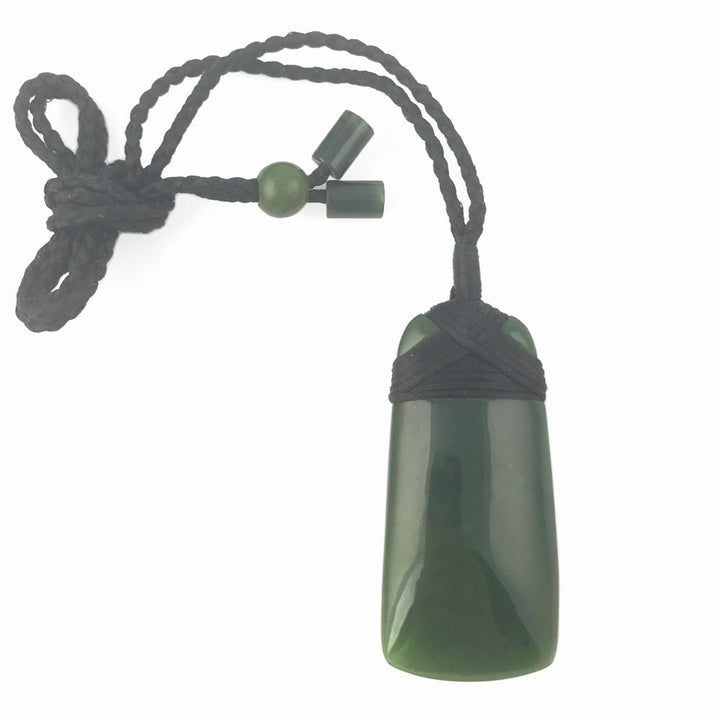 Green jade pendant on a black braided cord with round and small bead accents.
