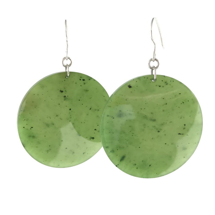 Pair of large round green jade earrings with silver hooks.