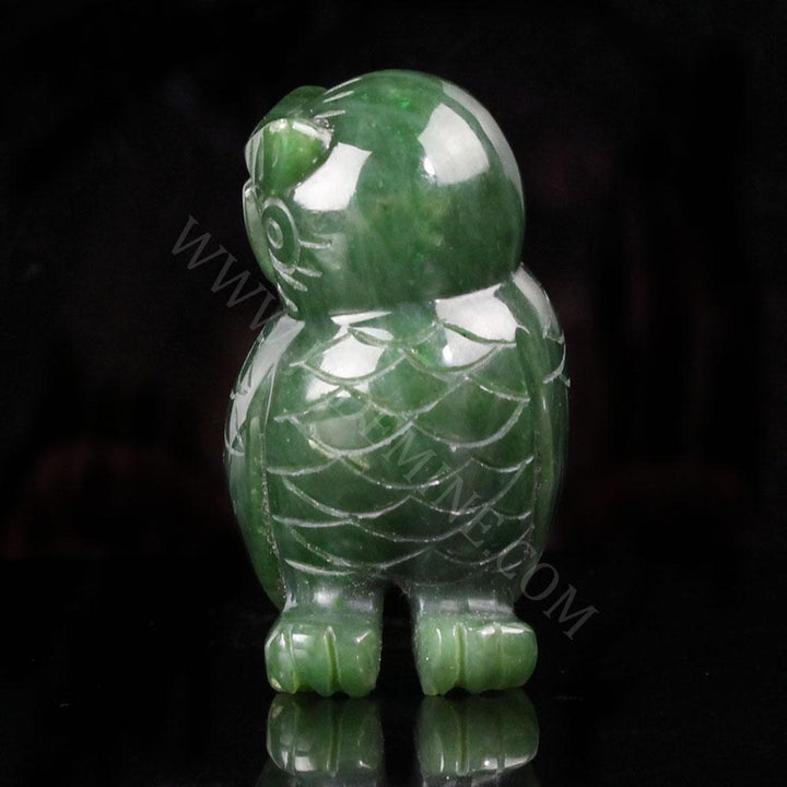 Front-facing green jade owl sculpture with round carved eyes and feather details on the chest