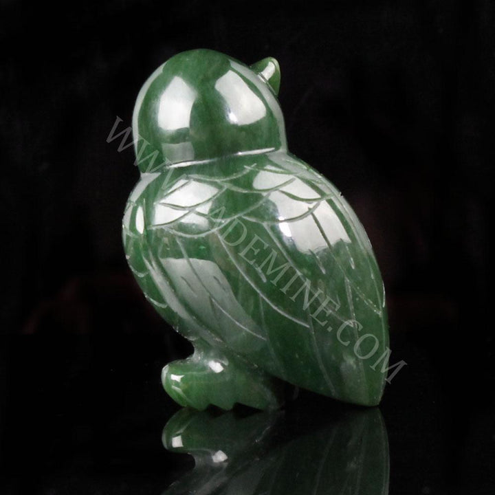 Green jade owl figurine with carved feather details and a glossy finish