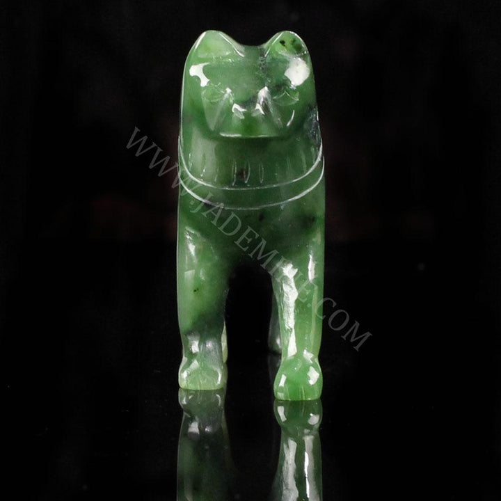 Front view of green jade husky statue standing on a black surface.