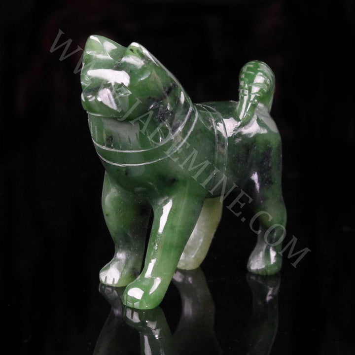 Green jade husky figurine with a raised head on a black background.