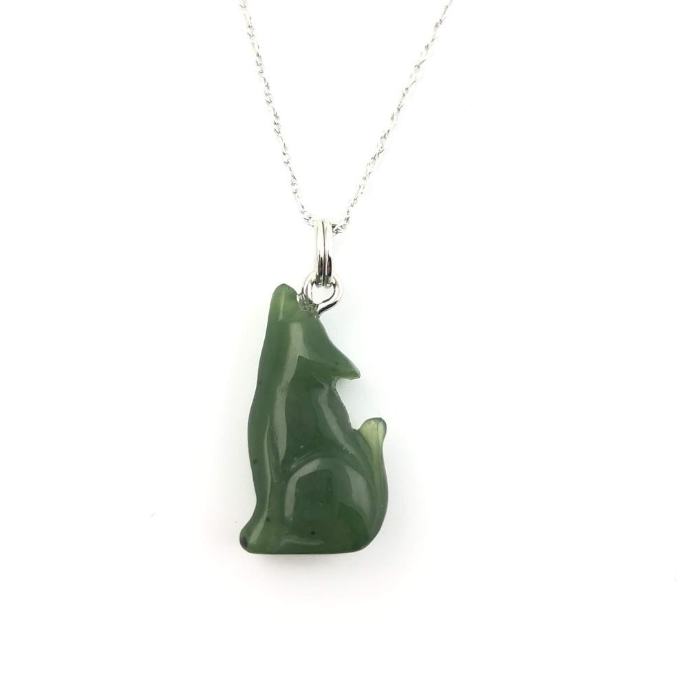 Green wolf pendant on a silver chain against a white background