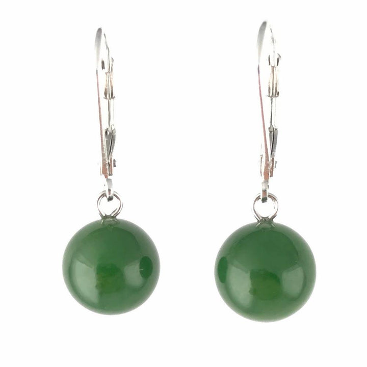 Green jade bead earrings featuring polished round beads on silver lever-back hooks.