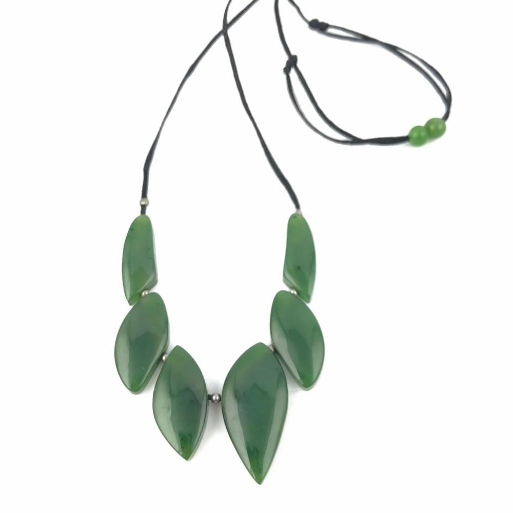 Jade necklace with large leaf shaped beads on a black cord