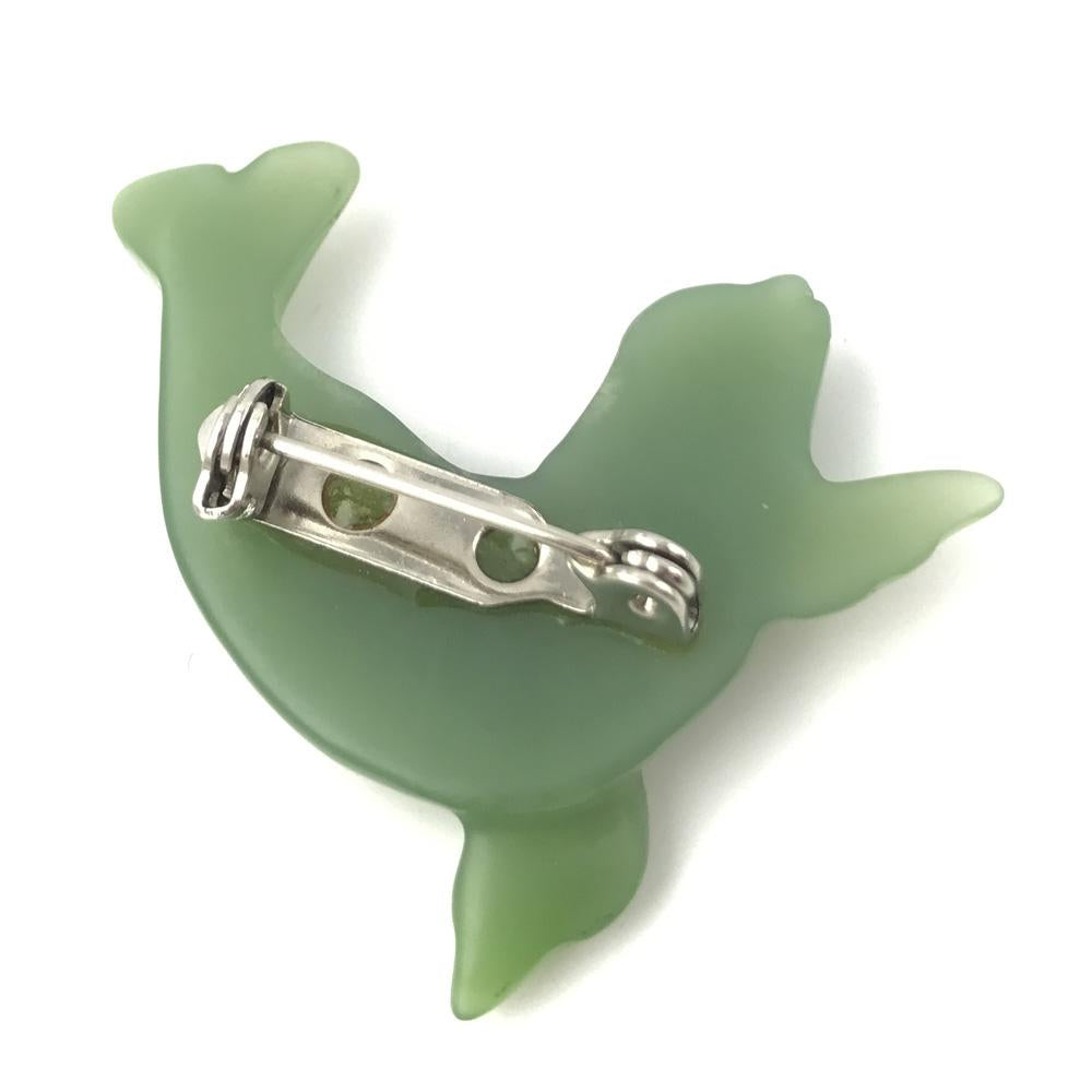 Back view of mint green seal shaped brooch showing pin clasp