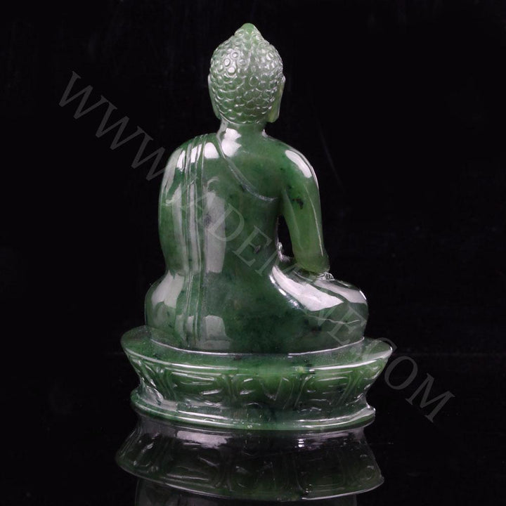 Back view of green jade Buddha statue seated in meditation on a lotus base