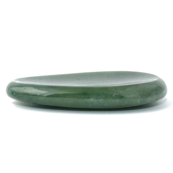 Green jade worry stone viewed from the side with a smooth glossy surface