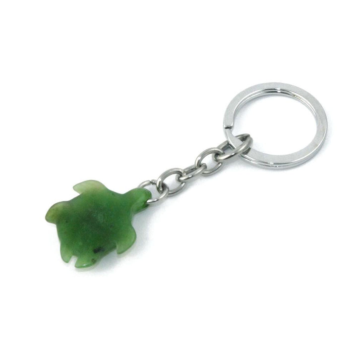 Green turtle charm on a silver keychain with a small linked chain.