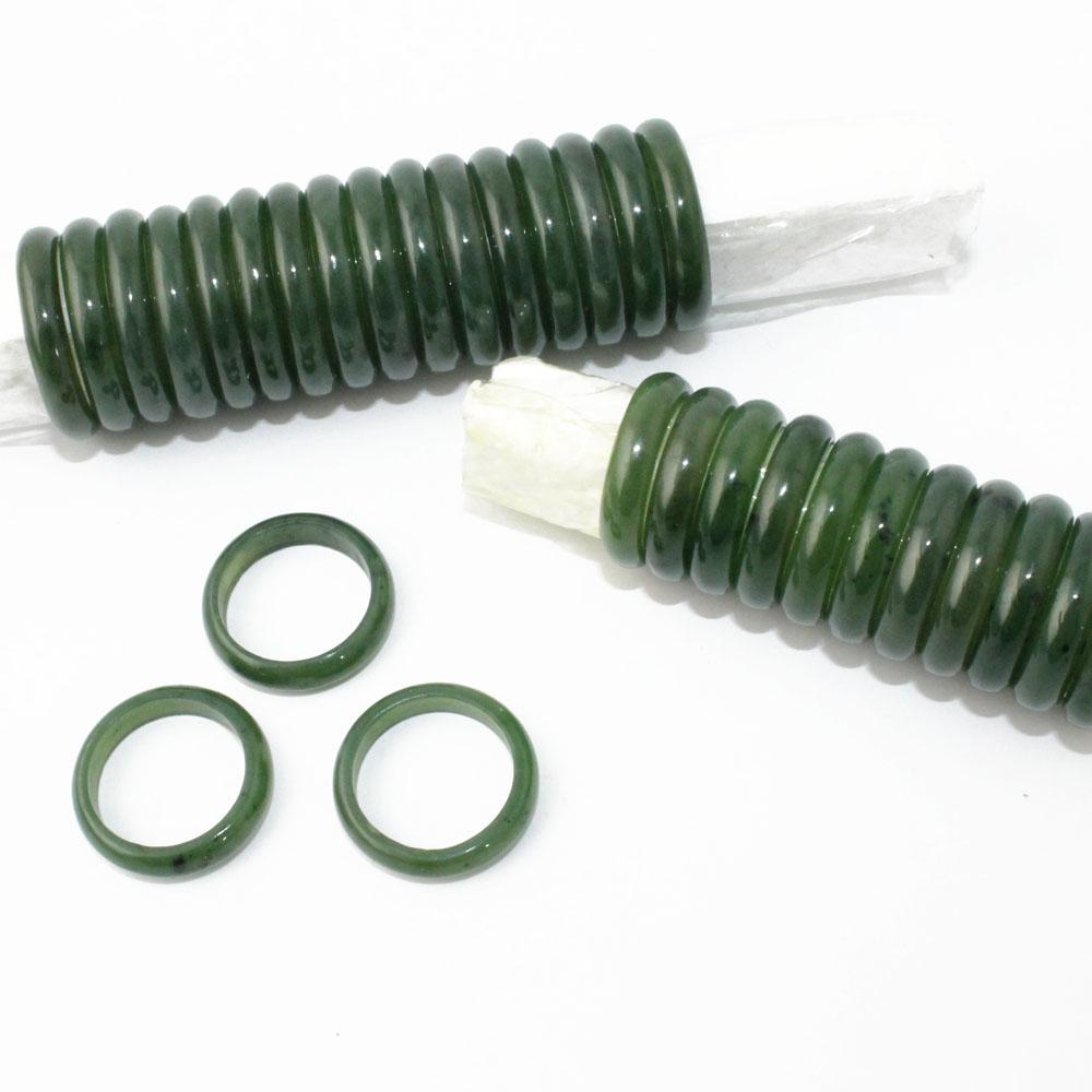 Dark green jade bead strand with three narrow jade band rings on white background