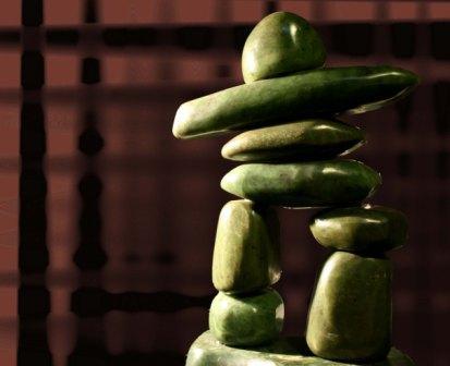 Green inukshuk on textured brown background