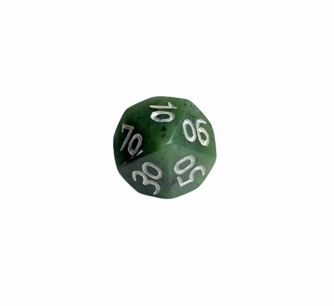 Green jade die with white numbers on its faces.