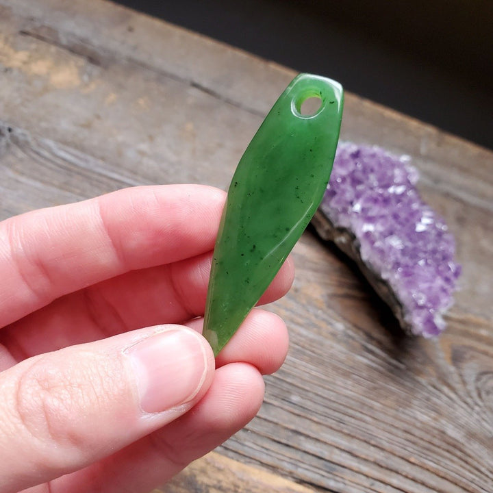 Large green drop pendant with a hole at the top for a chain, polished jade-like stone